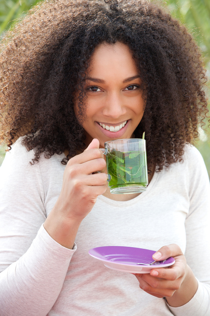 Young Woman Drinking Mint Tea